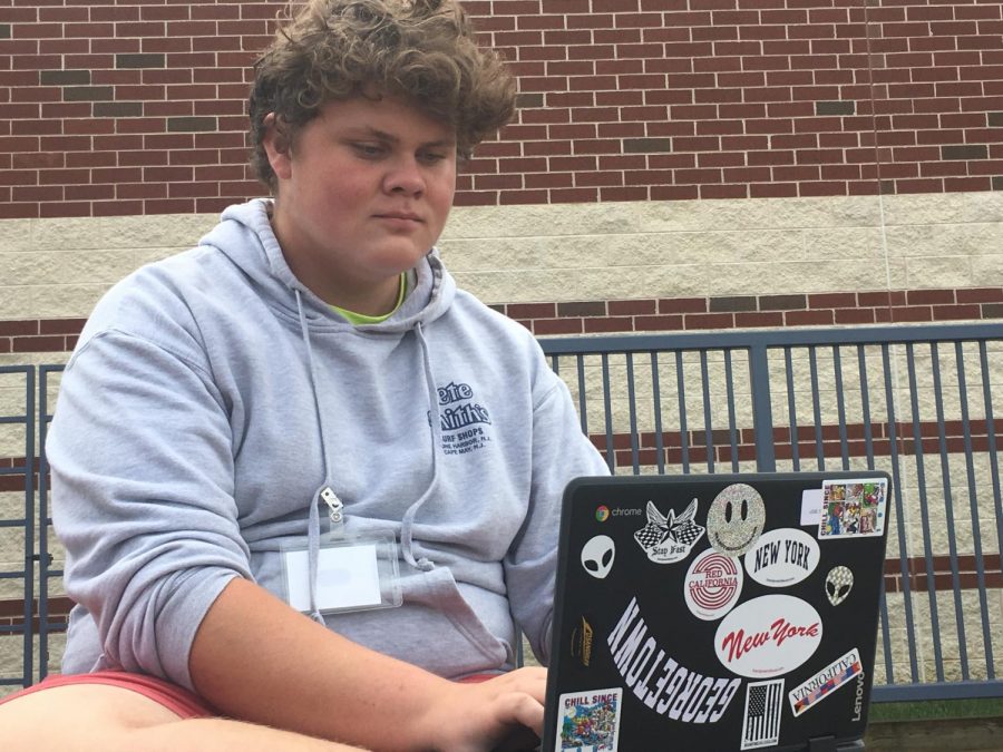 Sophomore Ryan Wilkinson works diligently on his sticker-coated Chromebook.