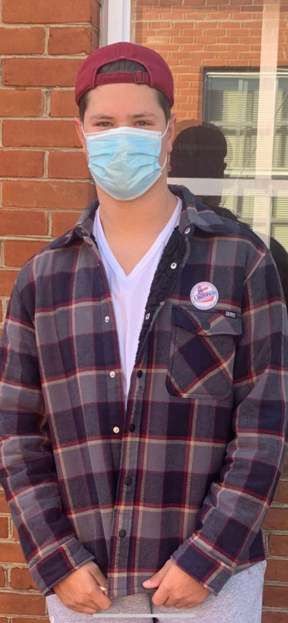 First time voter, Daniel Pavolic gets his picture taken by his mother in front of his voting location. 