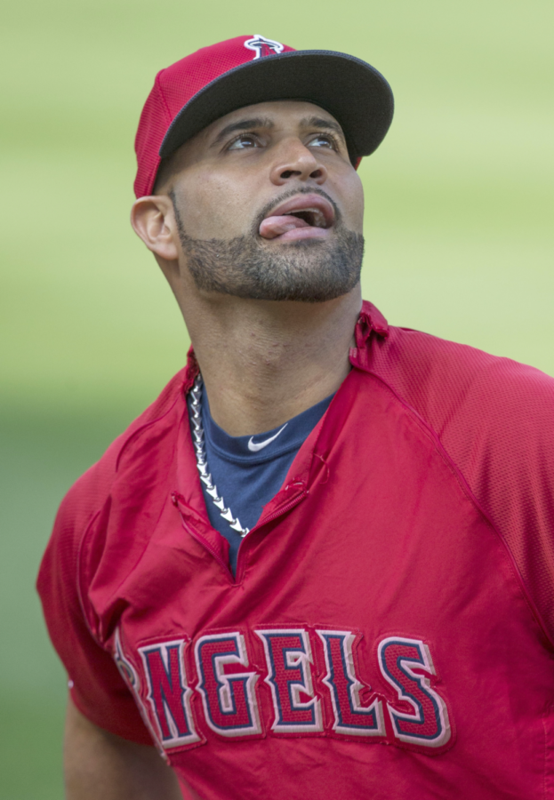 Pujols fields a ball going shallow behind first base.