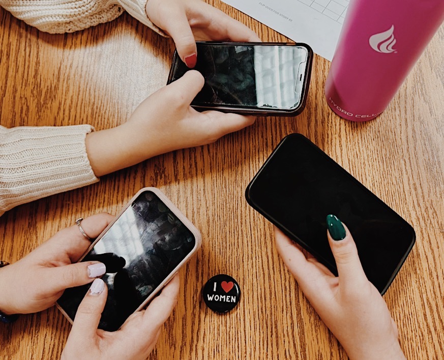 Young women using phone apps to track personal health. Photo provided by Virginia Walker.