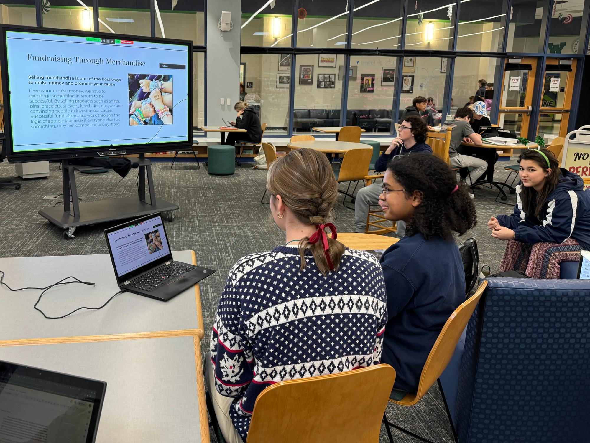 Senior Lily McBride and Junior Iman Etienne present their fundraising plan to Ukrainian students. Photo provided by Mr. Matthew Talboo.