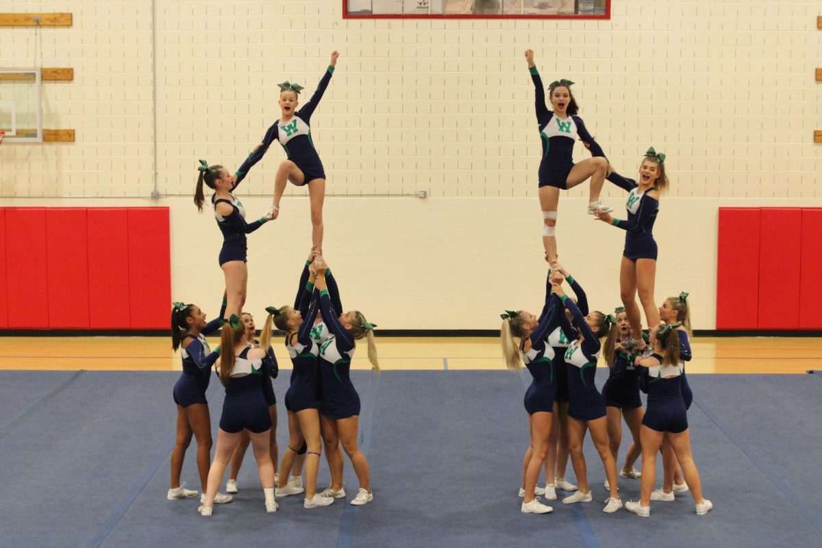 Woodgrove Varsity Cheer team warms up at Parkview with a mini pyramid for a competition. Photo provided by Lifetouch.