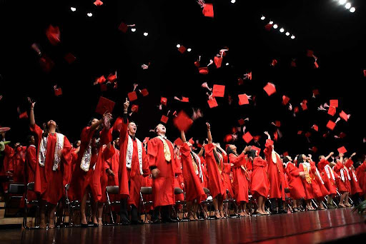 Seniors throw their caps in the air at their high school graduation ceremony. Picture provided by Creative Commons.