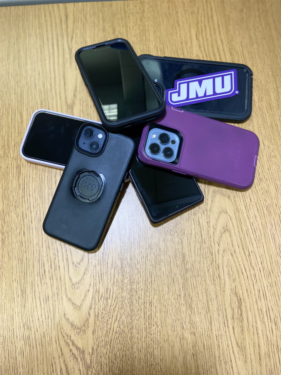 Students pile their “hours of endless scrolling devices” on a desk for the day. Photo provided by Mya Haines.