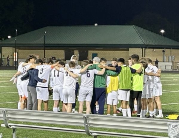 The boys’ Varsity Soccer team huddles after a hard-fought match during the 2023 season. Photo provided by Evan Kaiser.
