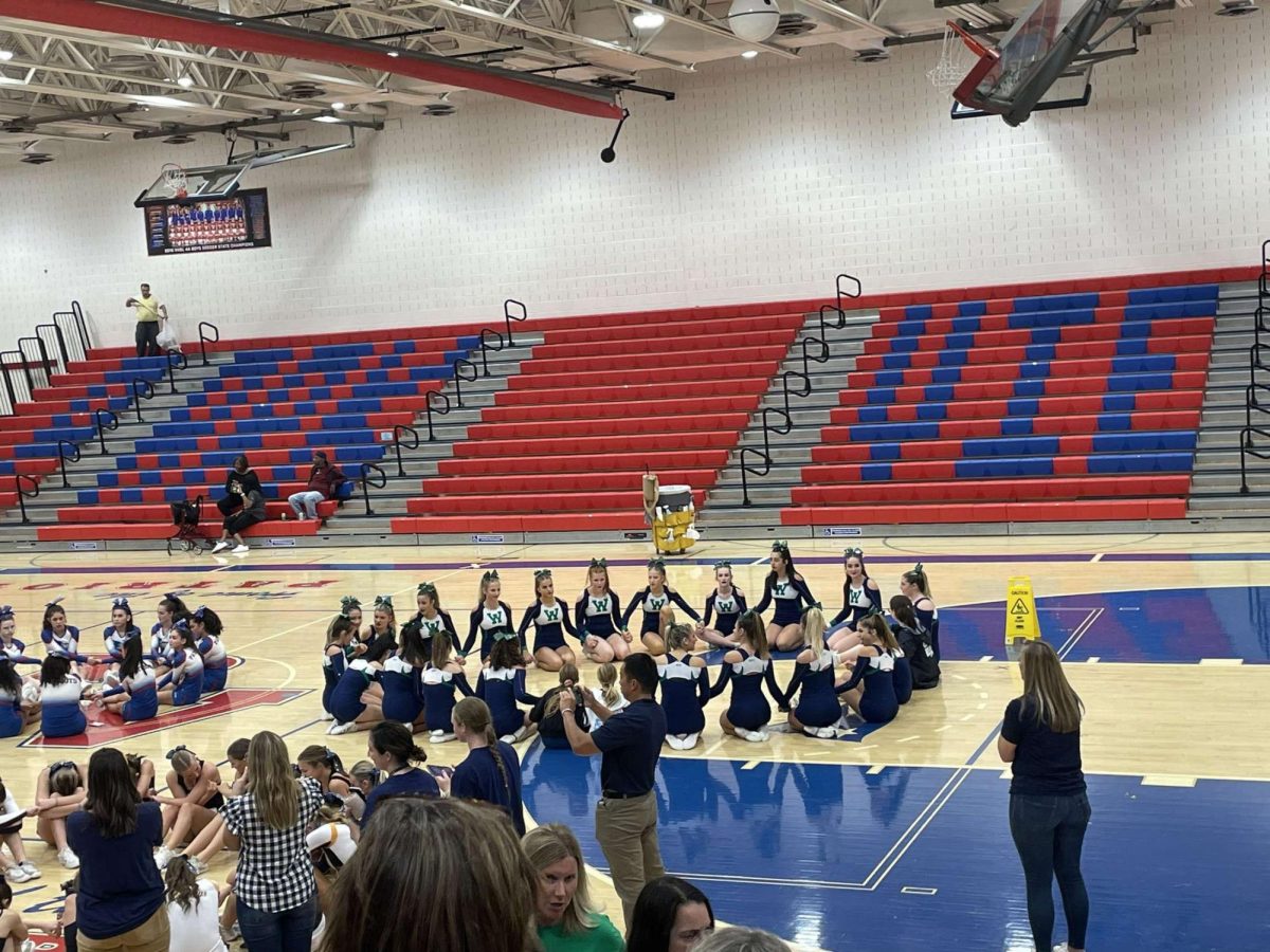 Woodgrove cheerleaders huddle together during a competition at Park View High School on October 4th, 2023. Photo provided by Taylor Wilson.