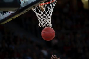 A basketball falls through the net at the 2024 March Madness Tournament. Photo provided by Creative Commons.
