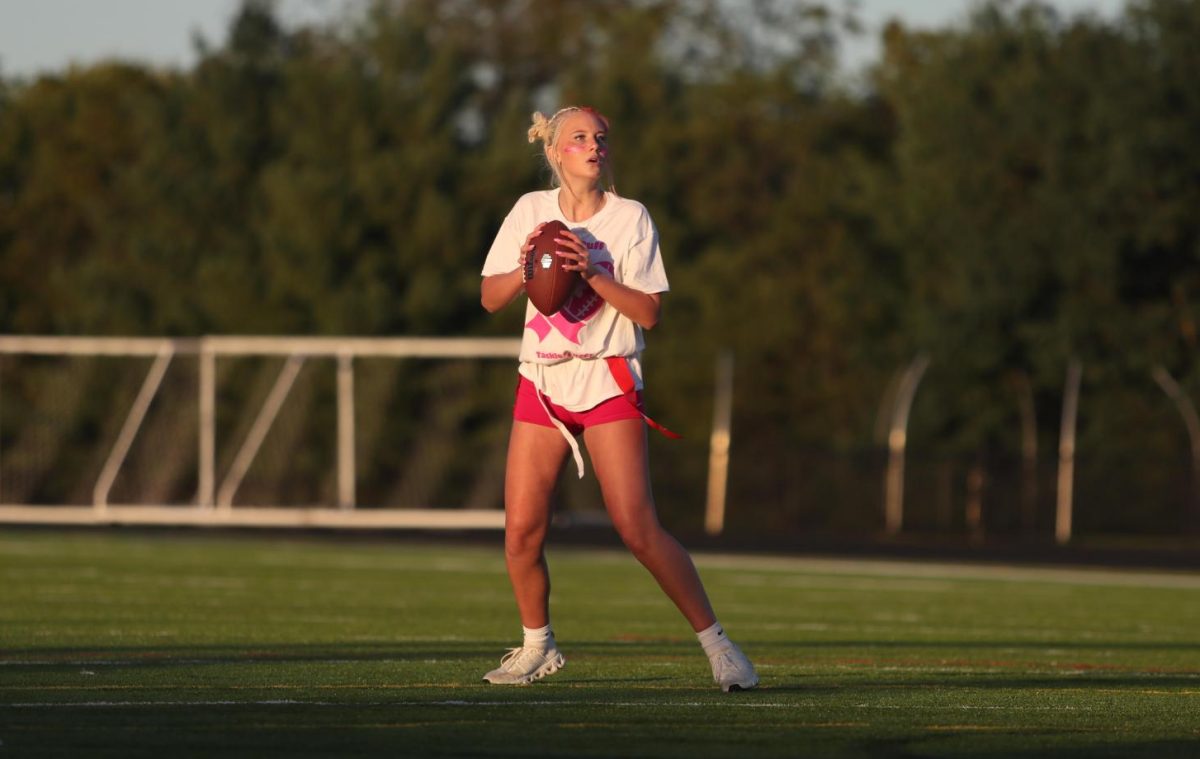 Quarterback for the Junior team, Autumn Garrison, throws the football mid-game. Photo provided by Legacy Studios.