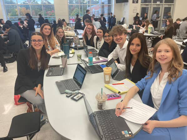 Junior Maddie Williams, Senior Kassidy Donohoe, Freshman Caden Vannoy, Senior Amanda Dickson, Sophomores Arabella Horton and Jackie Jimenez, Senior Tristen Demetriou, Sophomore Bree Mohler, and Junior Allyson Brake (in order from left to right) at a competition at Dominion High School.