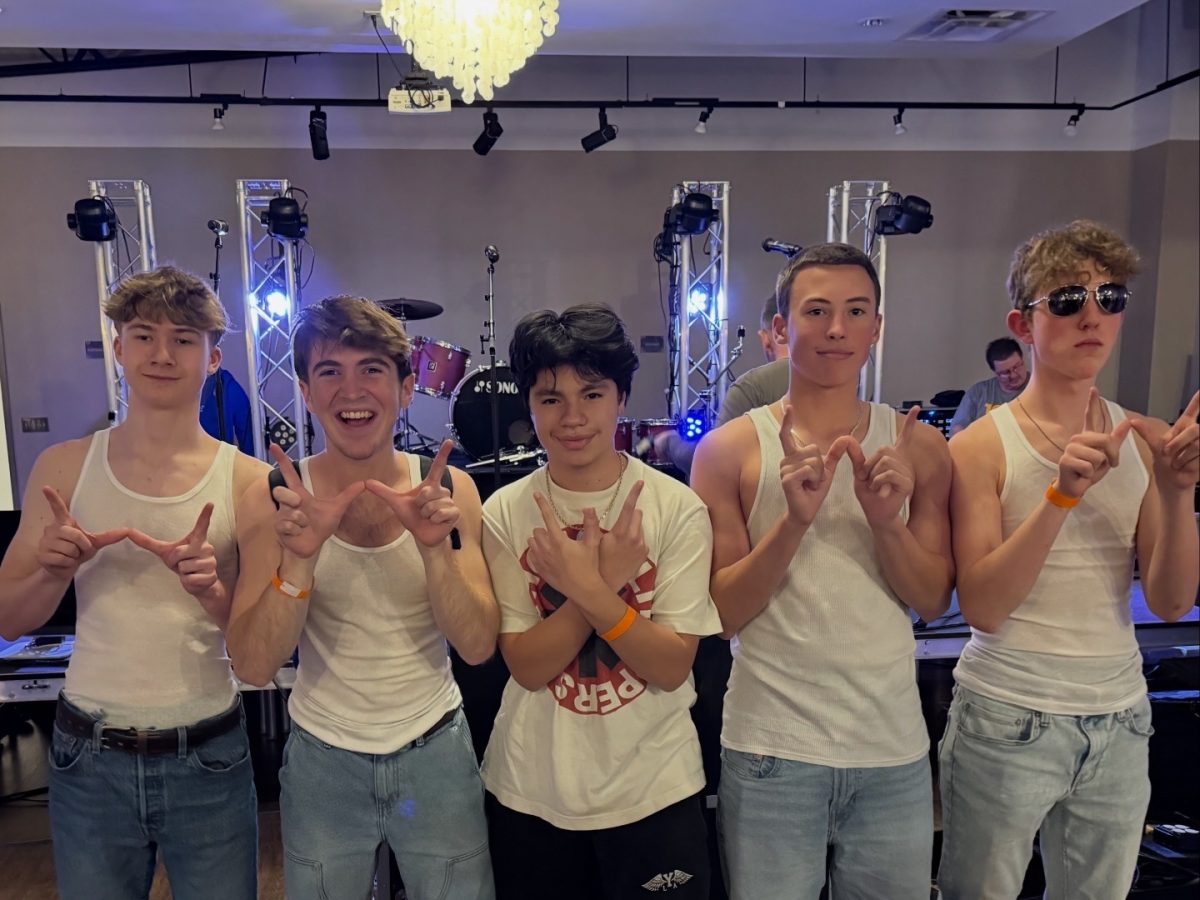 Pictured from left to right, Clay Macduffee, Spencer Newbold, GC Jusino Ramirez, Kahlo Thomas, 
and Wesley Chase smile at the end of a performance. Photo provided by Spencer Newbold. 