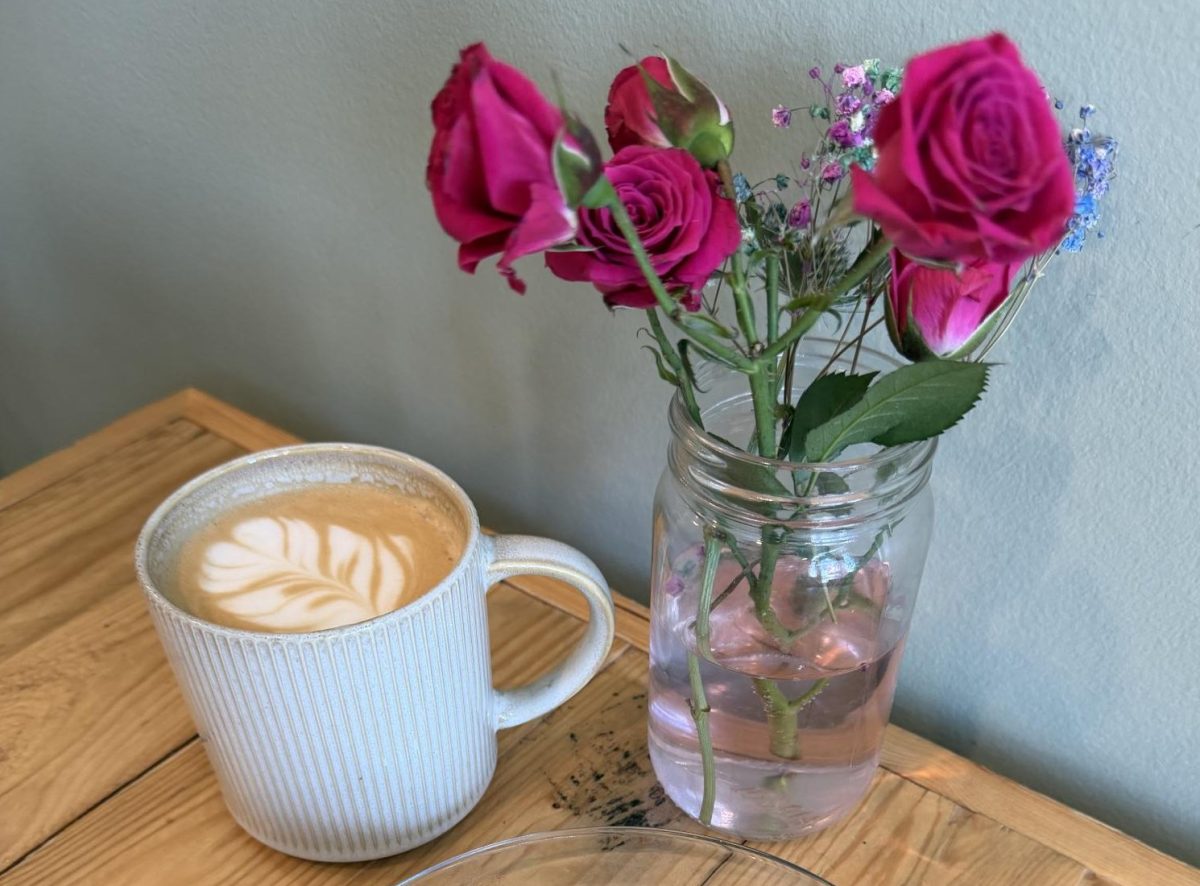 A Doppio Bunny latte and grilled cheese sandwhich sits next to a jar of flowers. Photo provided by Ashley Rayburn.
