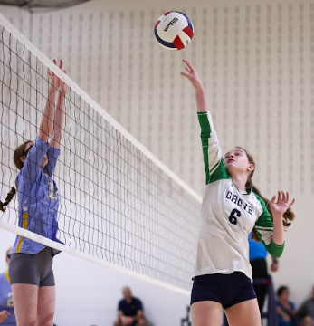 Violet Lilis tipping the ball over the net at a volleyball game. Photo provided by Mrs. Chelsea Dyke
