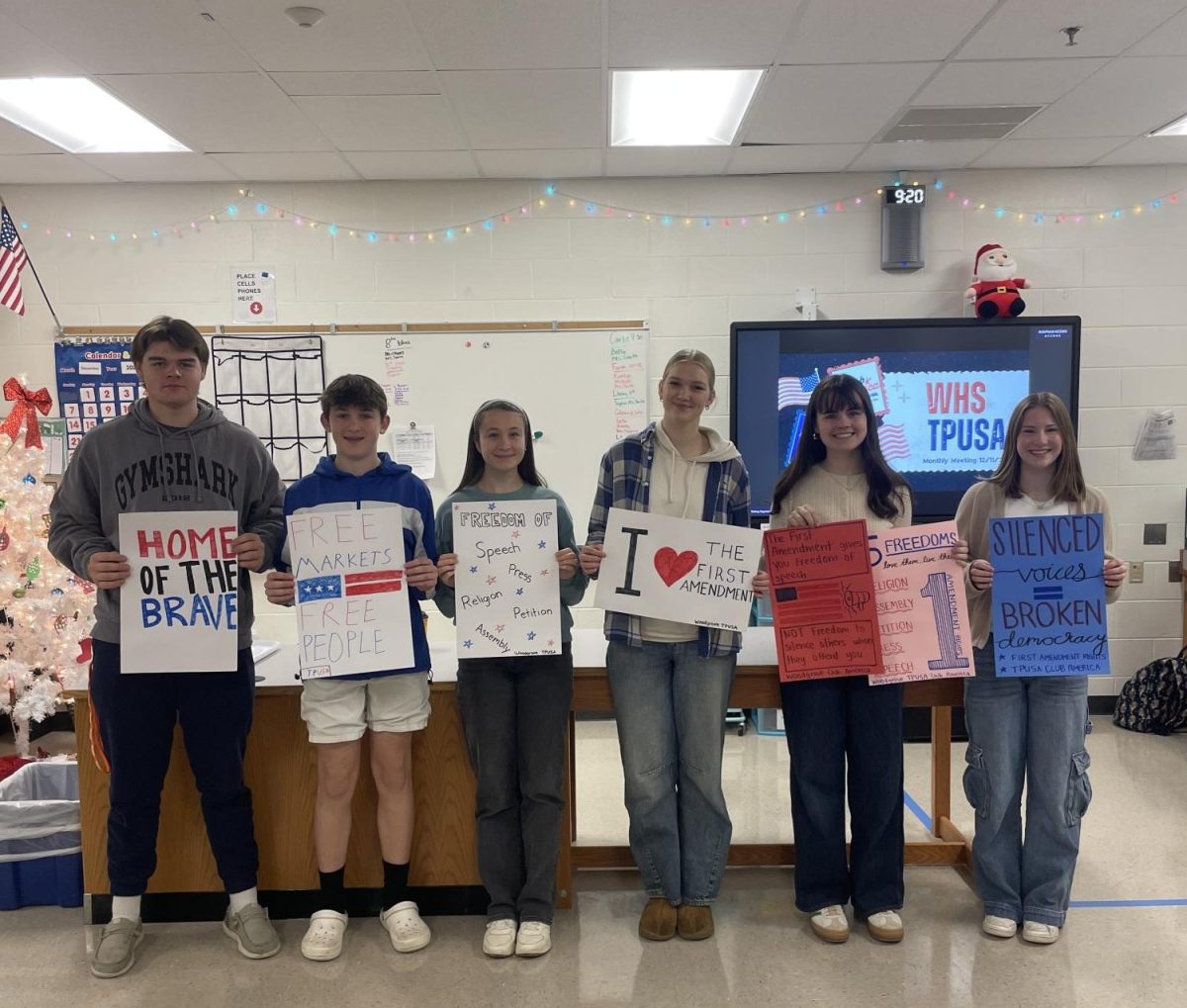 After a lesson on the First Amendment, members of TPUSA show off their handmade signs. Photo provided by Anna Verhey.  